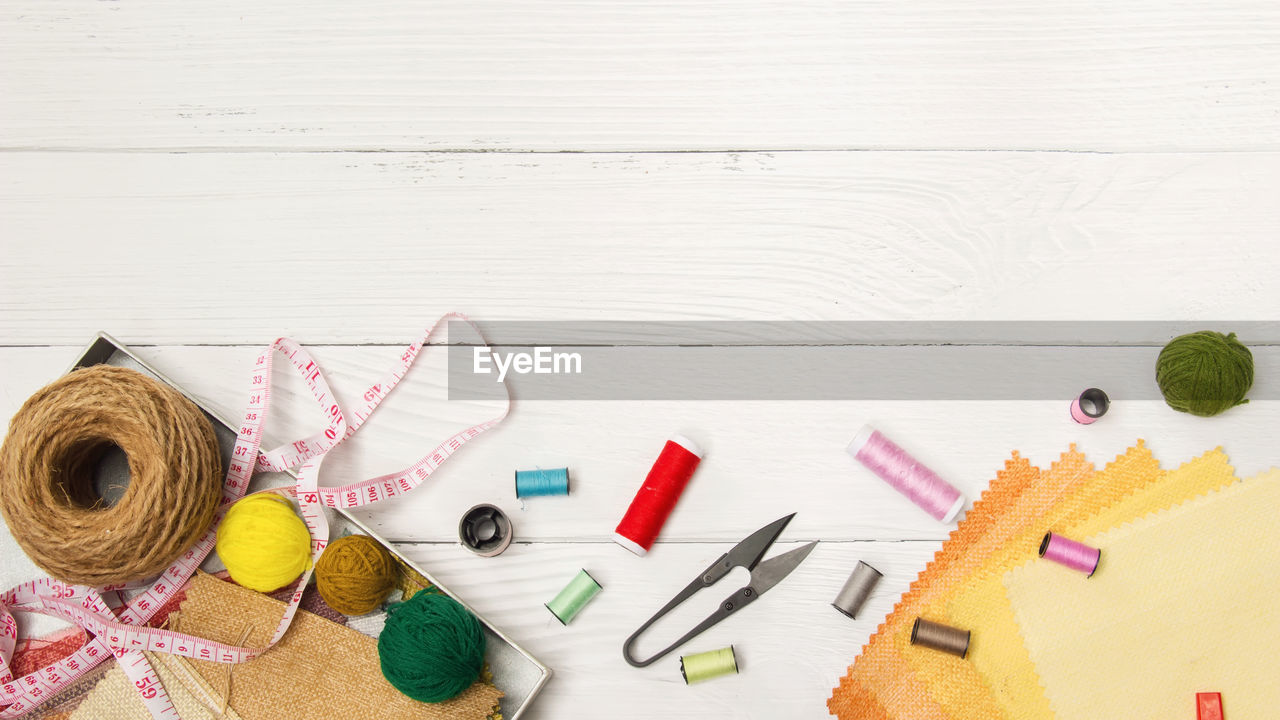 High angle view of multi colored sewing items on table