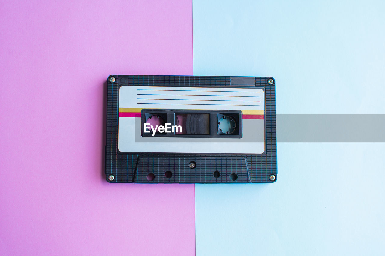 Directly above shot of audio cassette on colored background