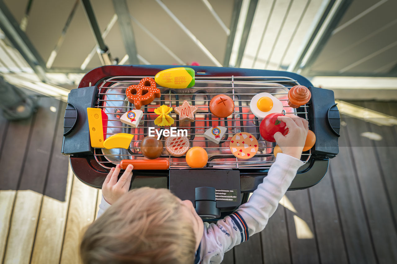 HIGH ANGLE VIEW OF PEOPLE WITH TOY STANDING