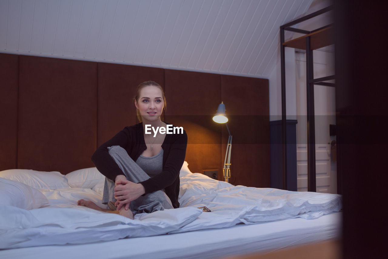 Woman watching tv on bed