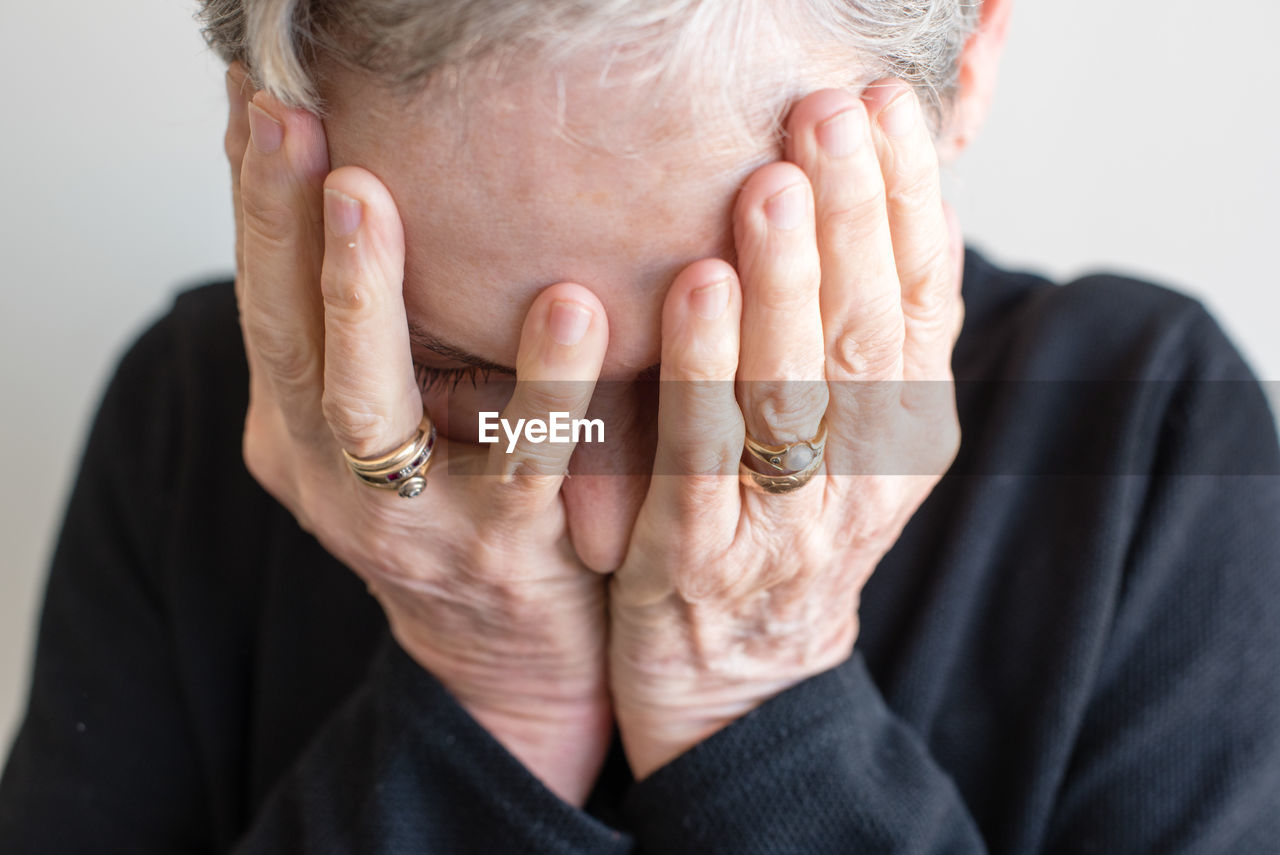 Midsection of woman covering eyes