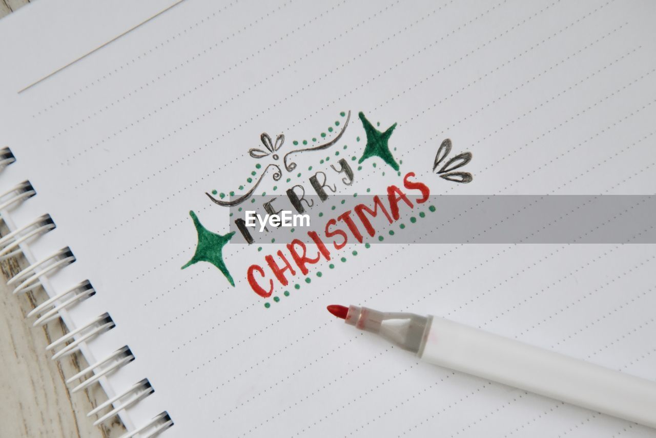 High angle view of merry christmas text on book