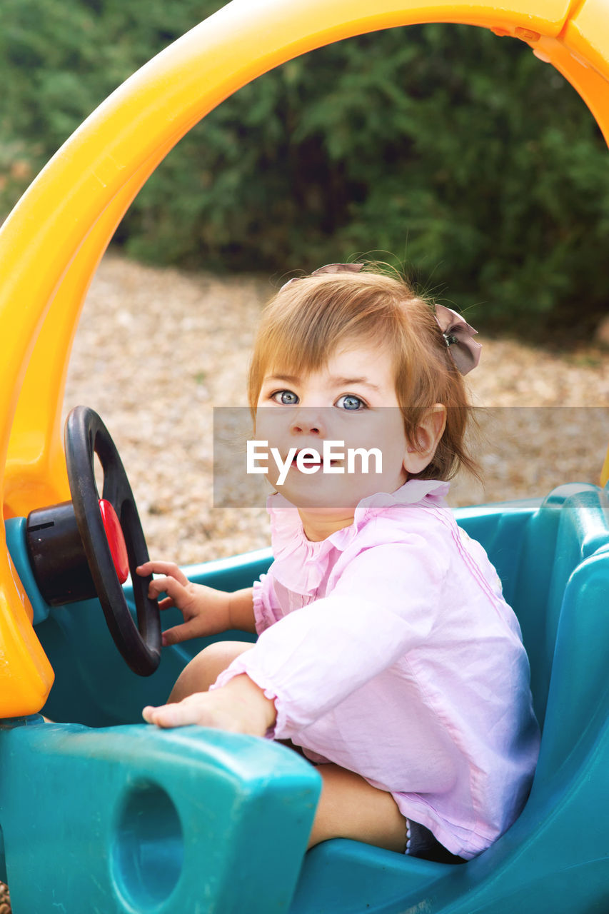 Cute baby girl sitting at park