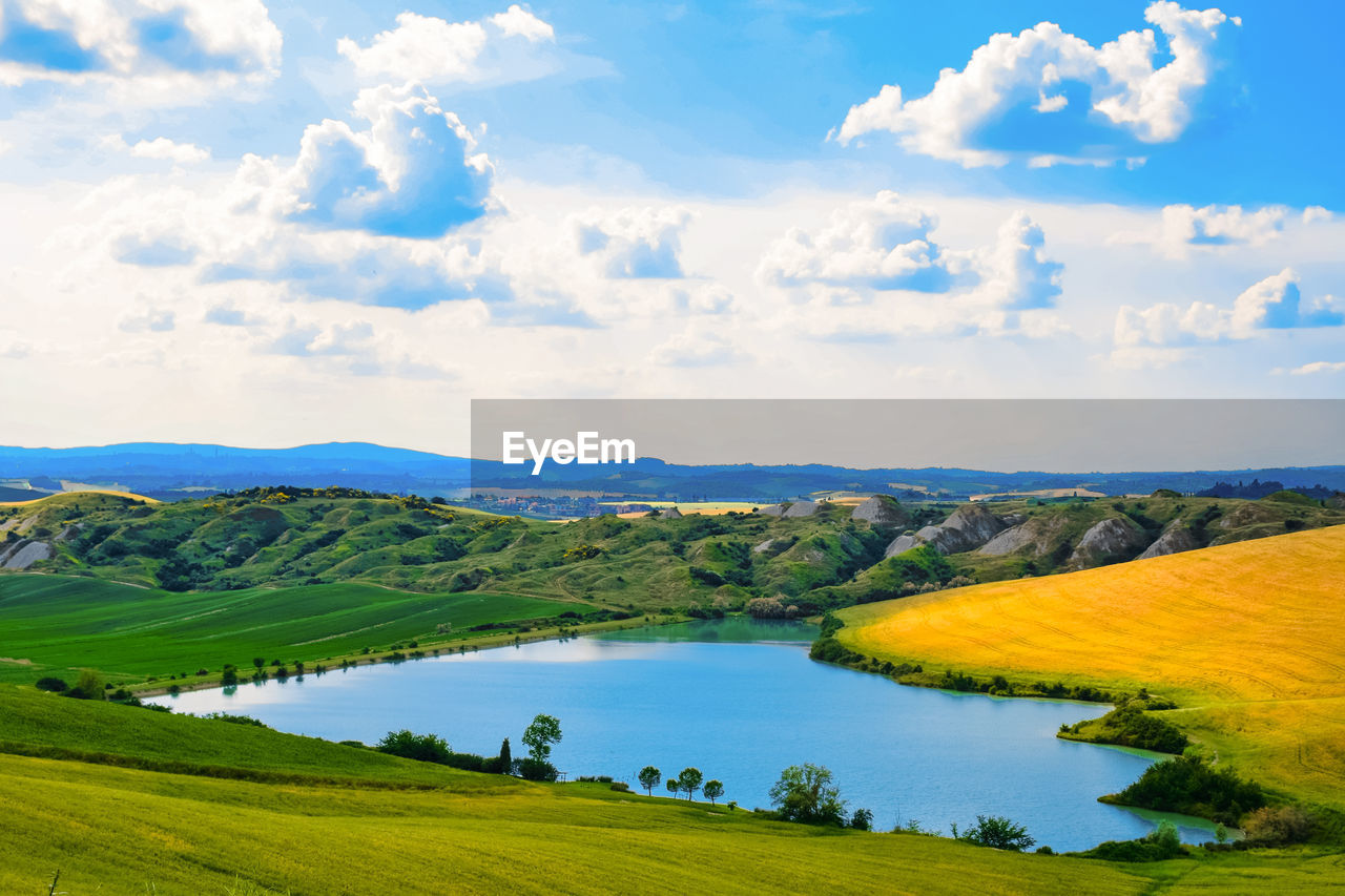 High angle view of lake amidst landscape against sky