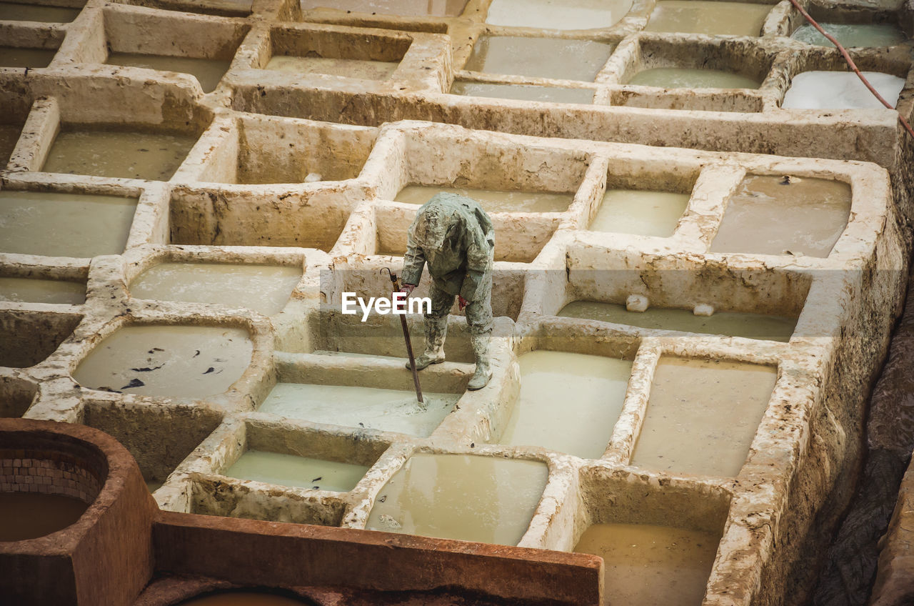 High angle view of man making leather at fes