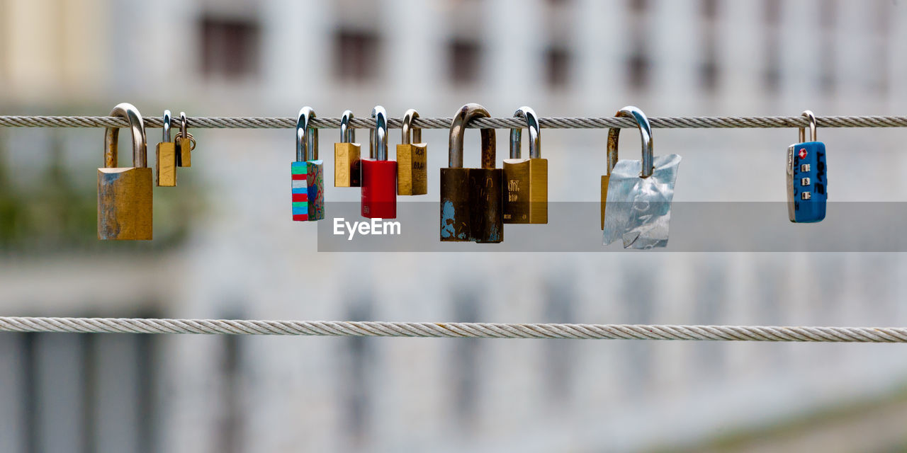 Close-up of love locks on cable