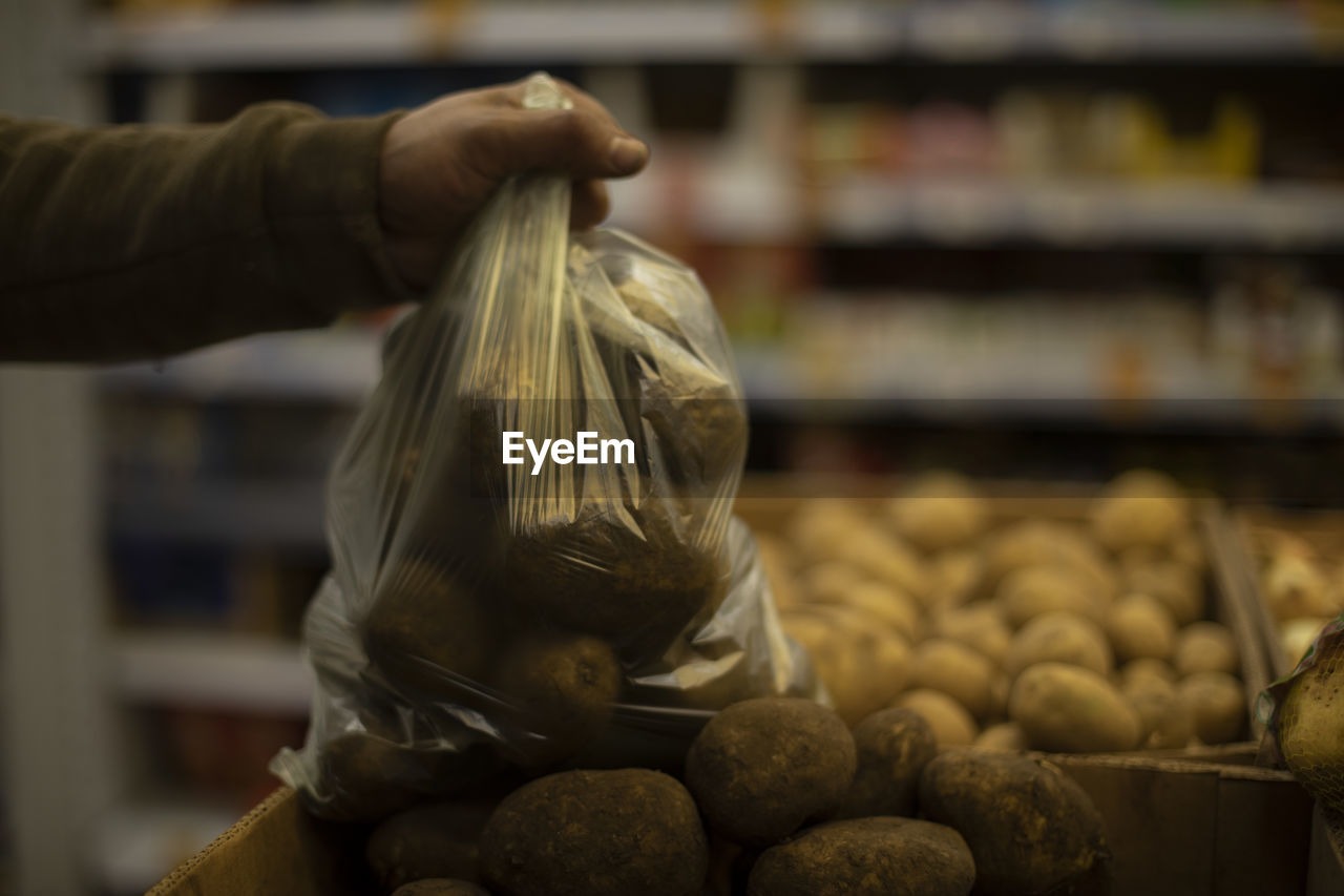 Bag with potatoes. vegetables in kitchen. potatoes in plastic bag. children of market. 