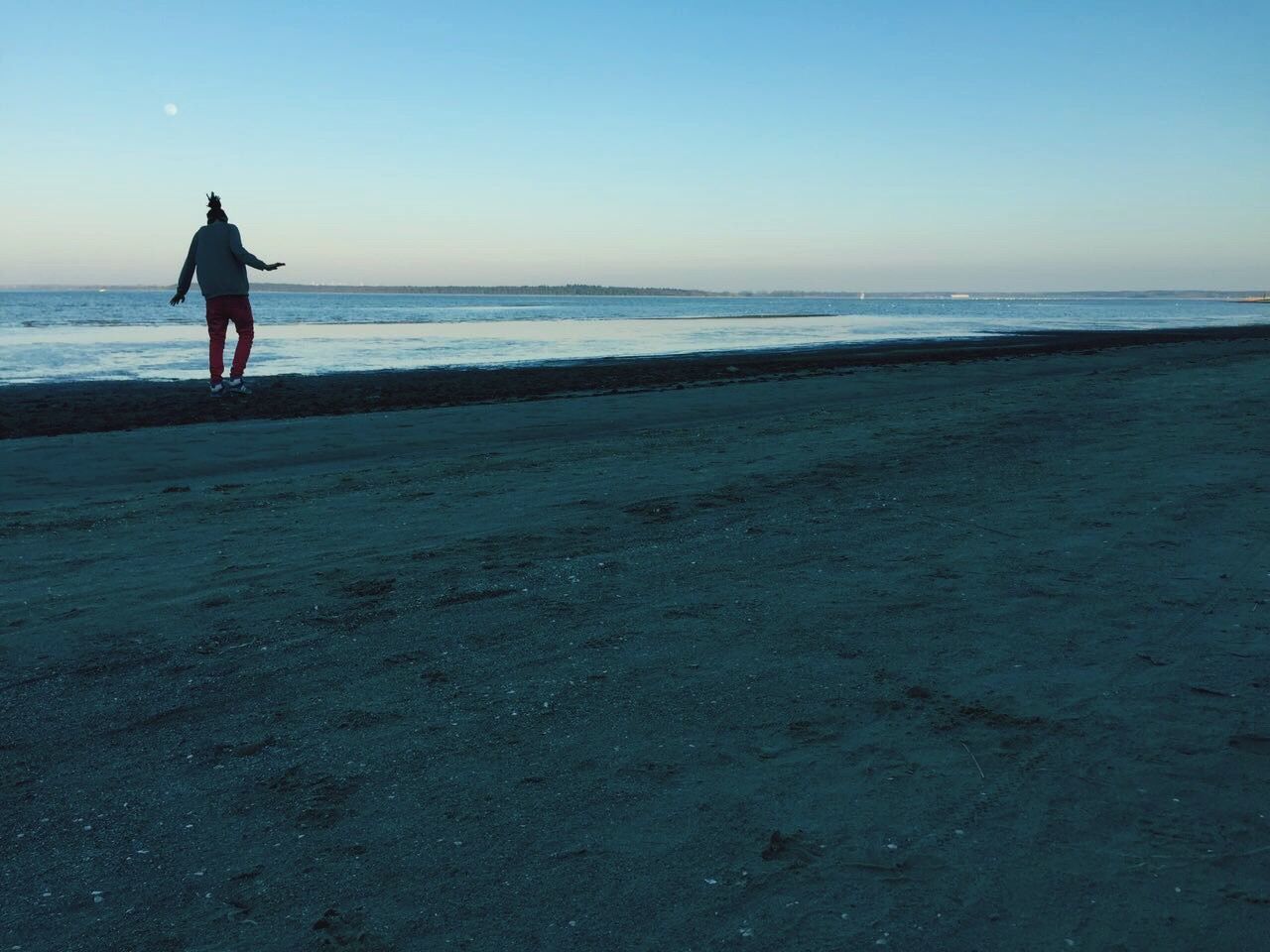 WOMAN ON BEACH AT SUNSET