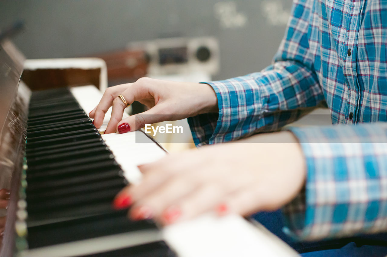 Close-up of woman playing piano