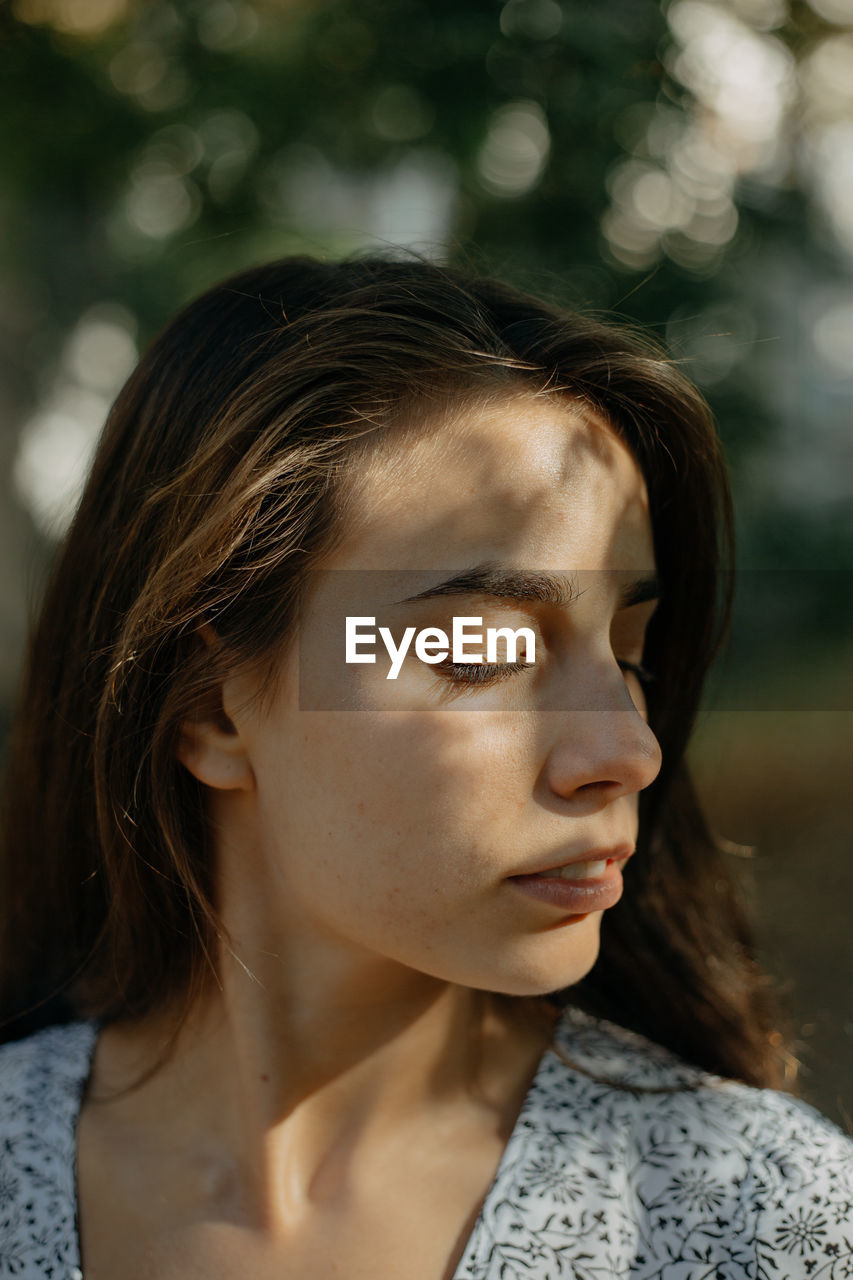 Close up portrait of a young woman with her eyes closed