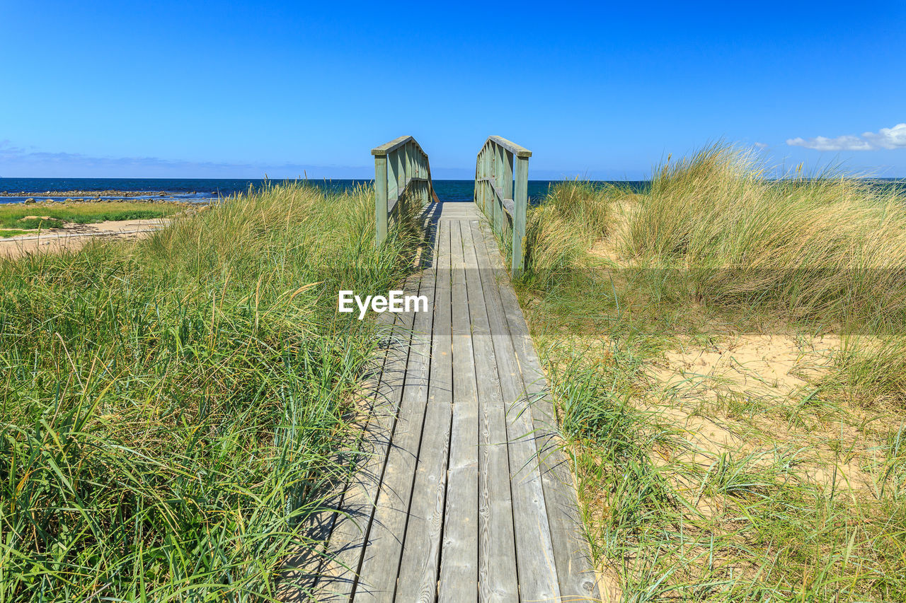 Scenic view of sea against clear blue sky