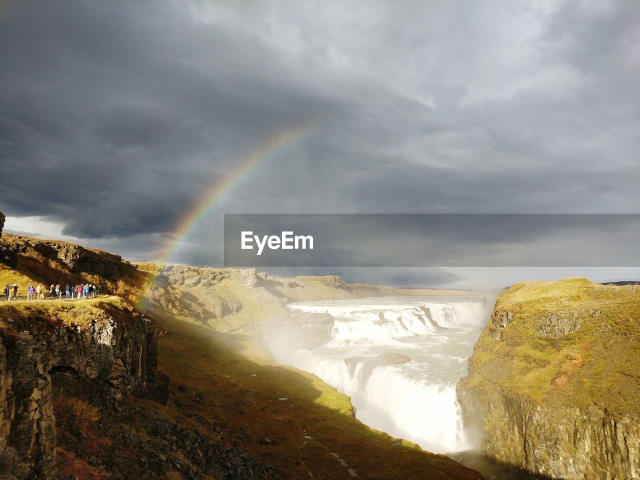 RAINBOW OVER LANDSCAPE AGAINST SKY