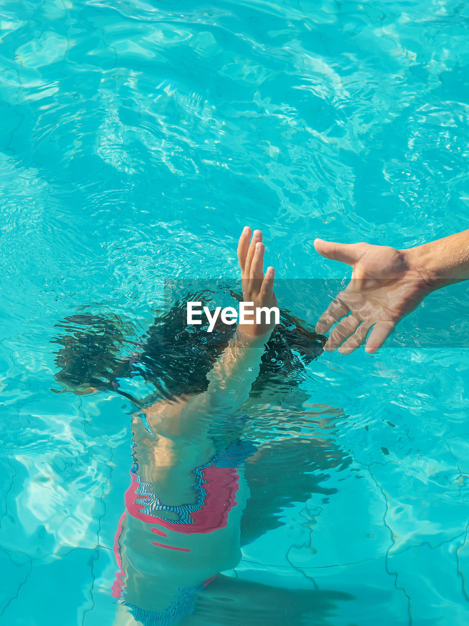 high angle view of woman swimming in pool