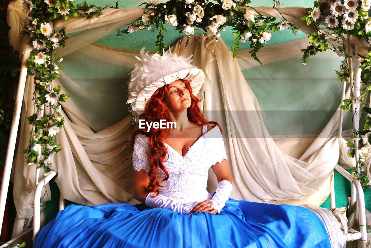 Bride sitting on decorated swing