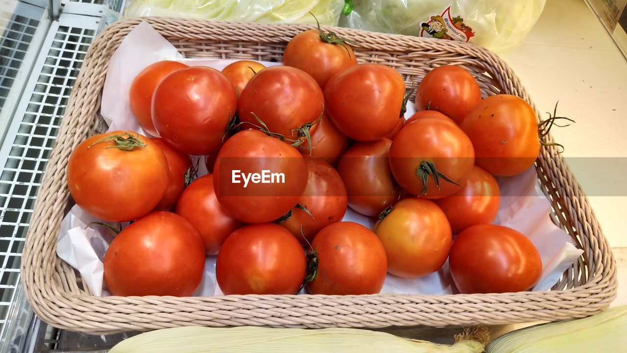 High angle view of tomatoes in basket on table at market