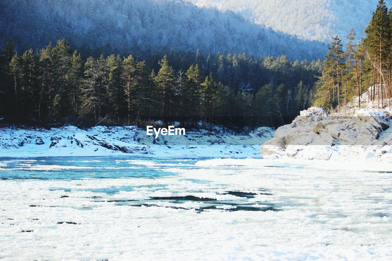 Scenic view of frozen lake with mountain in background