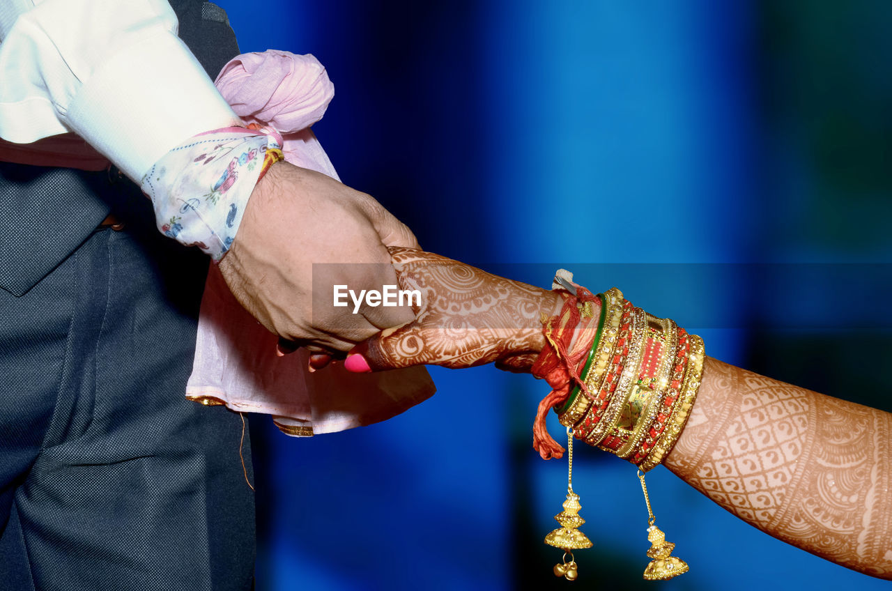 LOW ANGLE VIEW OF MAN HAND HOLDING UMBRELLA