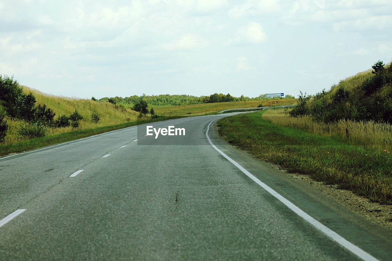 ROAD ALONG COUNTRYSIDE LANDSCAPE