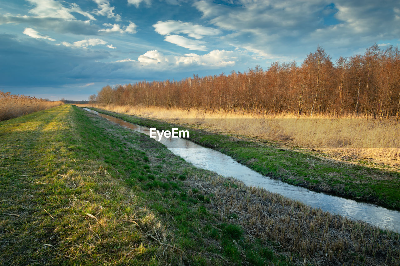 A dike by the uherka river in eastern poland, april day