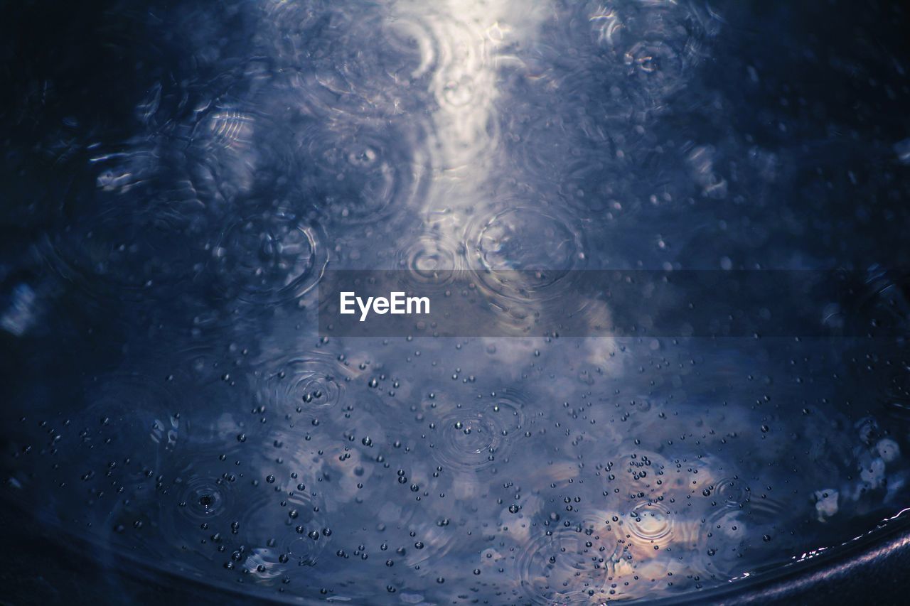 FULL FRAME SHOT OF RAINDROPS ON WET WINDSHIELD