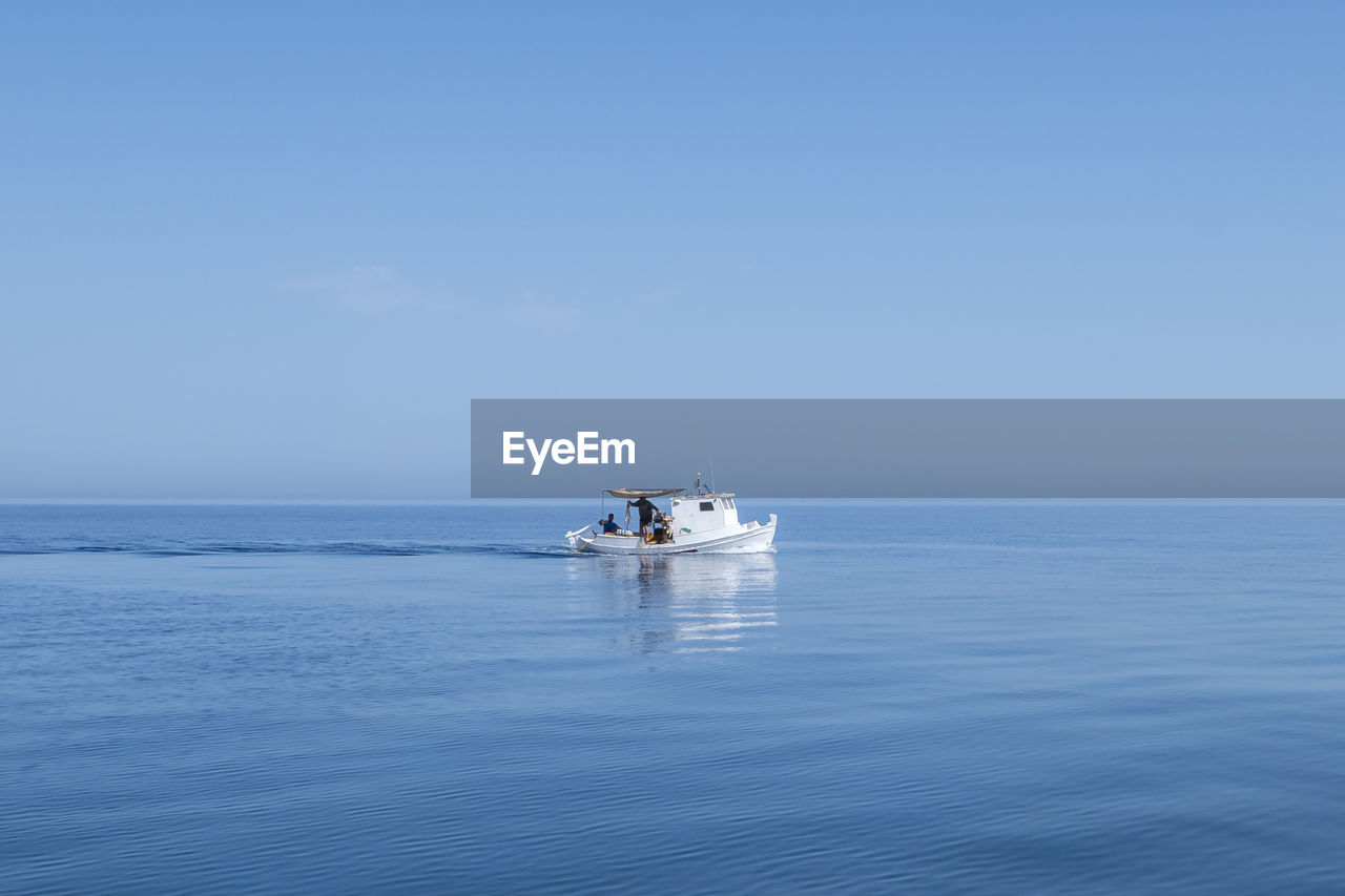 Boat sailing in sea against sky