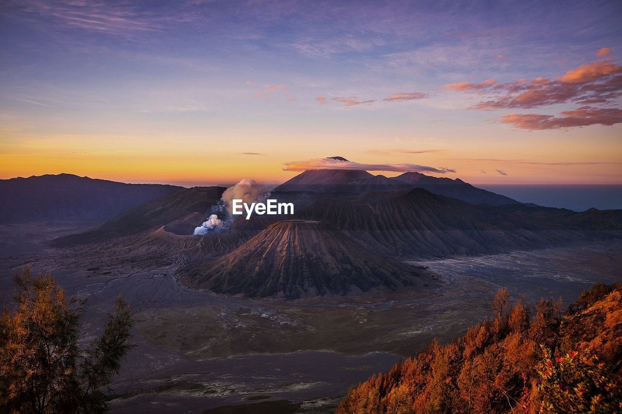 View of volcanic landscape against sky during sunset