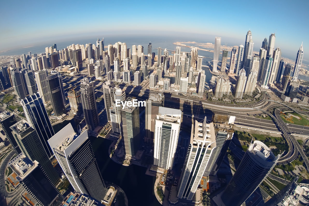 High angle view of modern buildings in city against sky