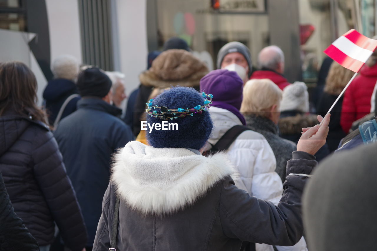 crowd, group of people, adult, winter, men, warm clothing, clothing, women, large group of people, architecture, person, day, rear view, togetherness, human face, fur, fur clothing, outdoors, city, celebration