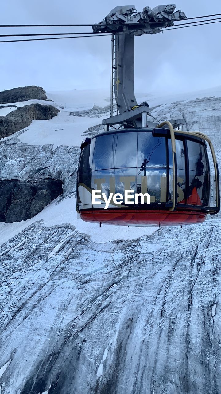 snow, cold temperature, transportation, winter, mode of transportation, vehicle, nature, environment, frozen, scenics - nature, landscape, water, travel, cable car, mountain, ice, helicopter, beauty in nature, no people, sky, day, outdoors, ski lift, nautical vessel, sea, cable, overhead cable car, non-urban scene, land