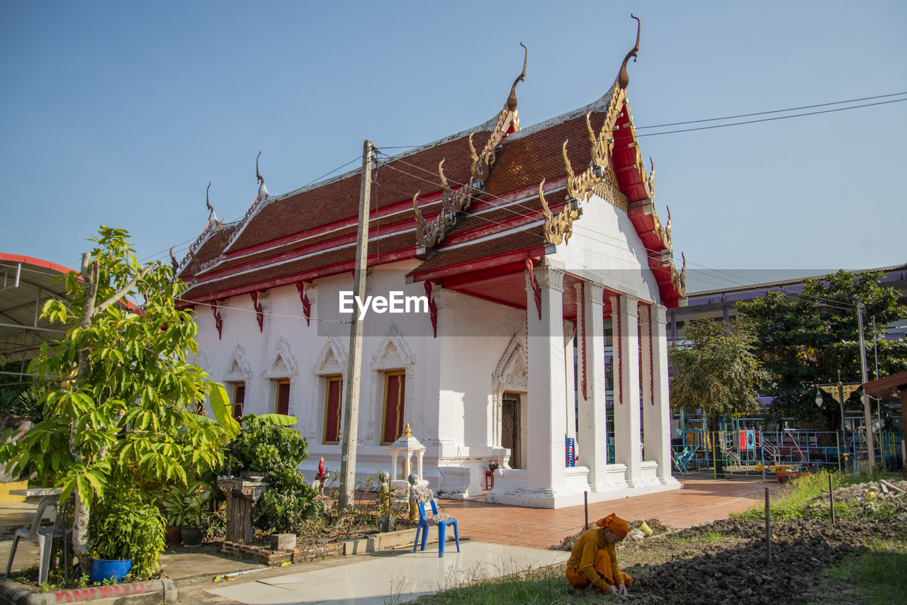 architecture, built structure, building exterior, building, temple, religion, nature, temple - building, travel destinations, belief, sky, plant, place of worship, travel, history, the past, tourism, spirituality, house, tree, tradition, outdoors, city, sunny, day, clear sky, no people, blue, pagoda, vacation