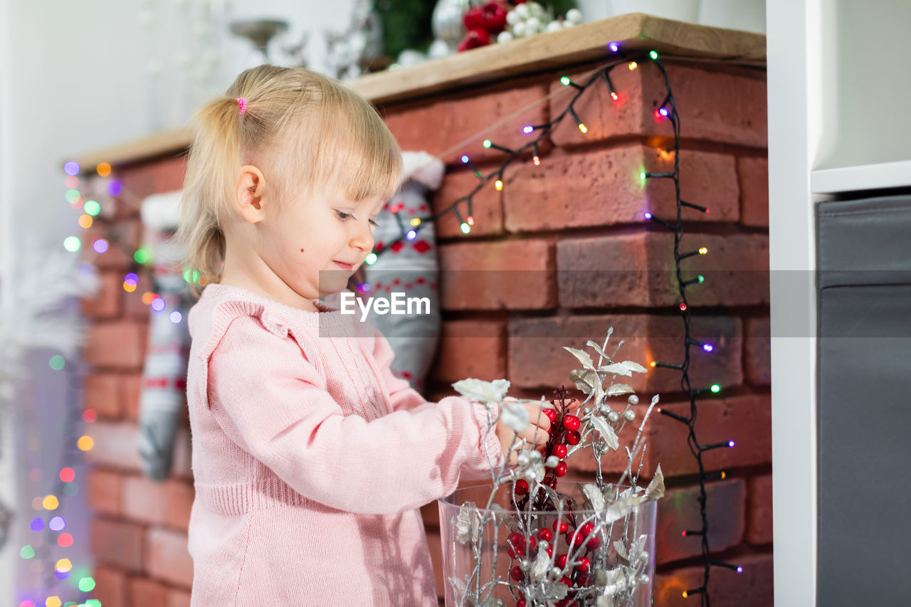 side view of cute girl playing with toys