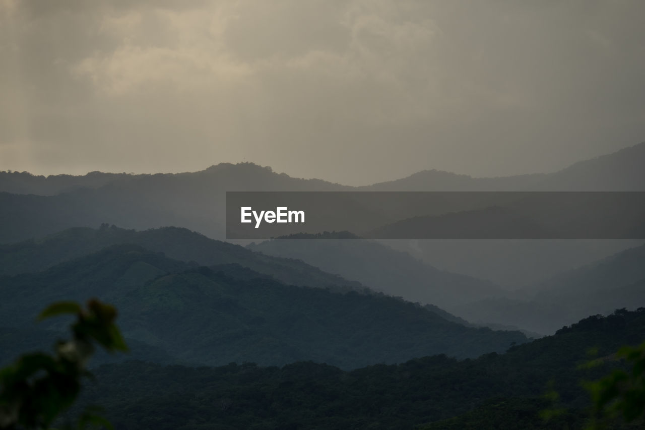 Scenic view of mountains against dramatic sky