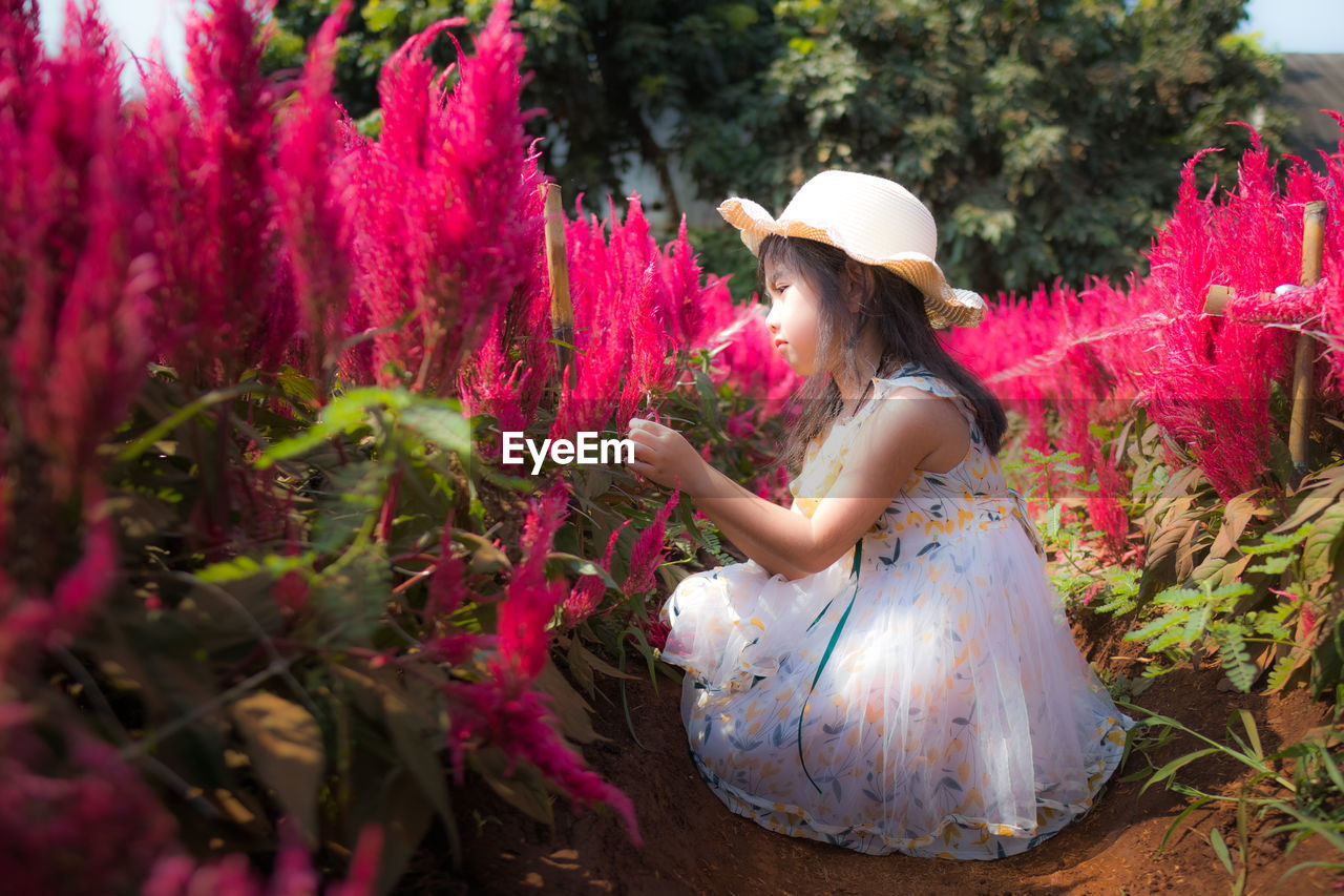 Side view of a woman with pink flowers