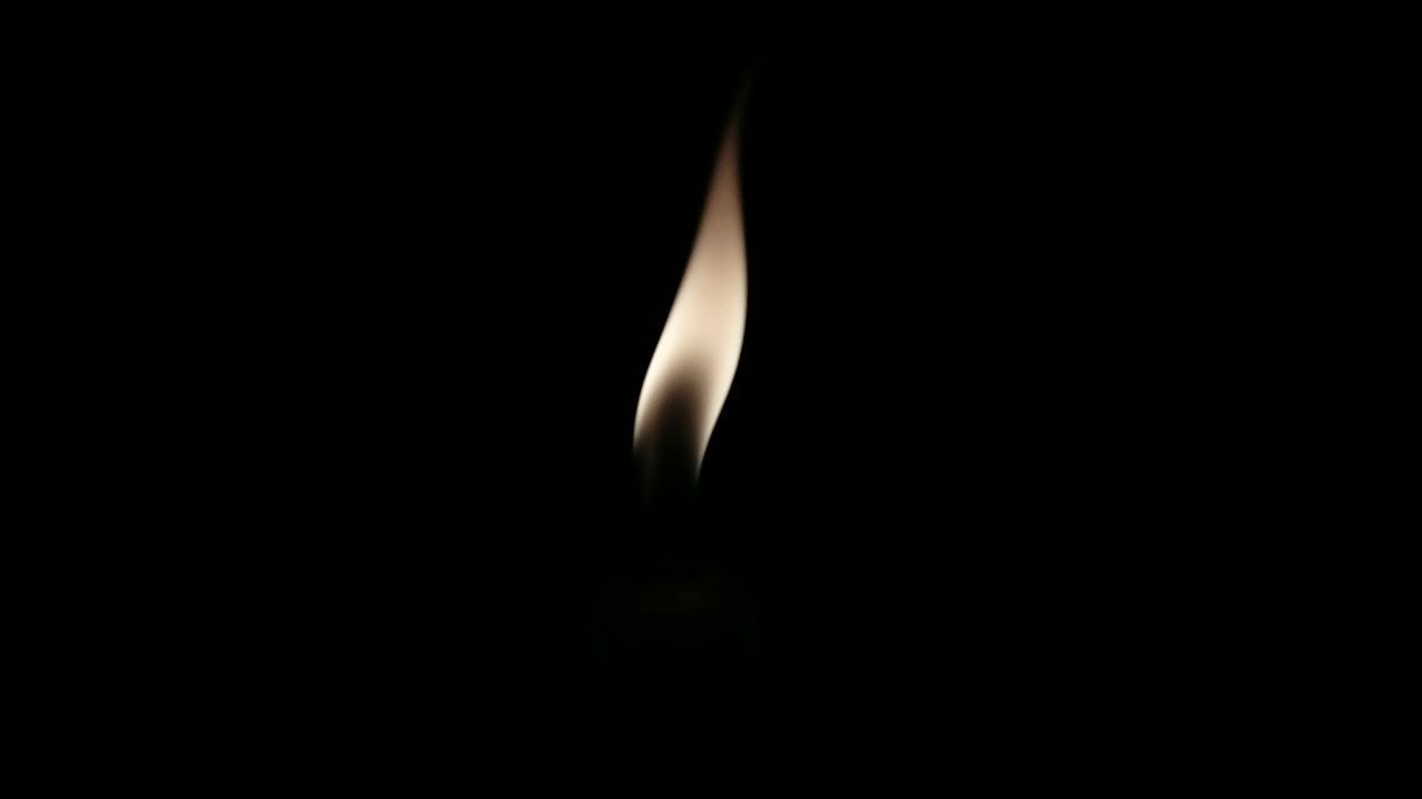 Close-up of flame of black background