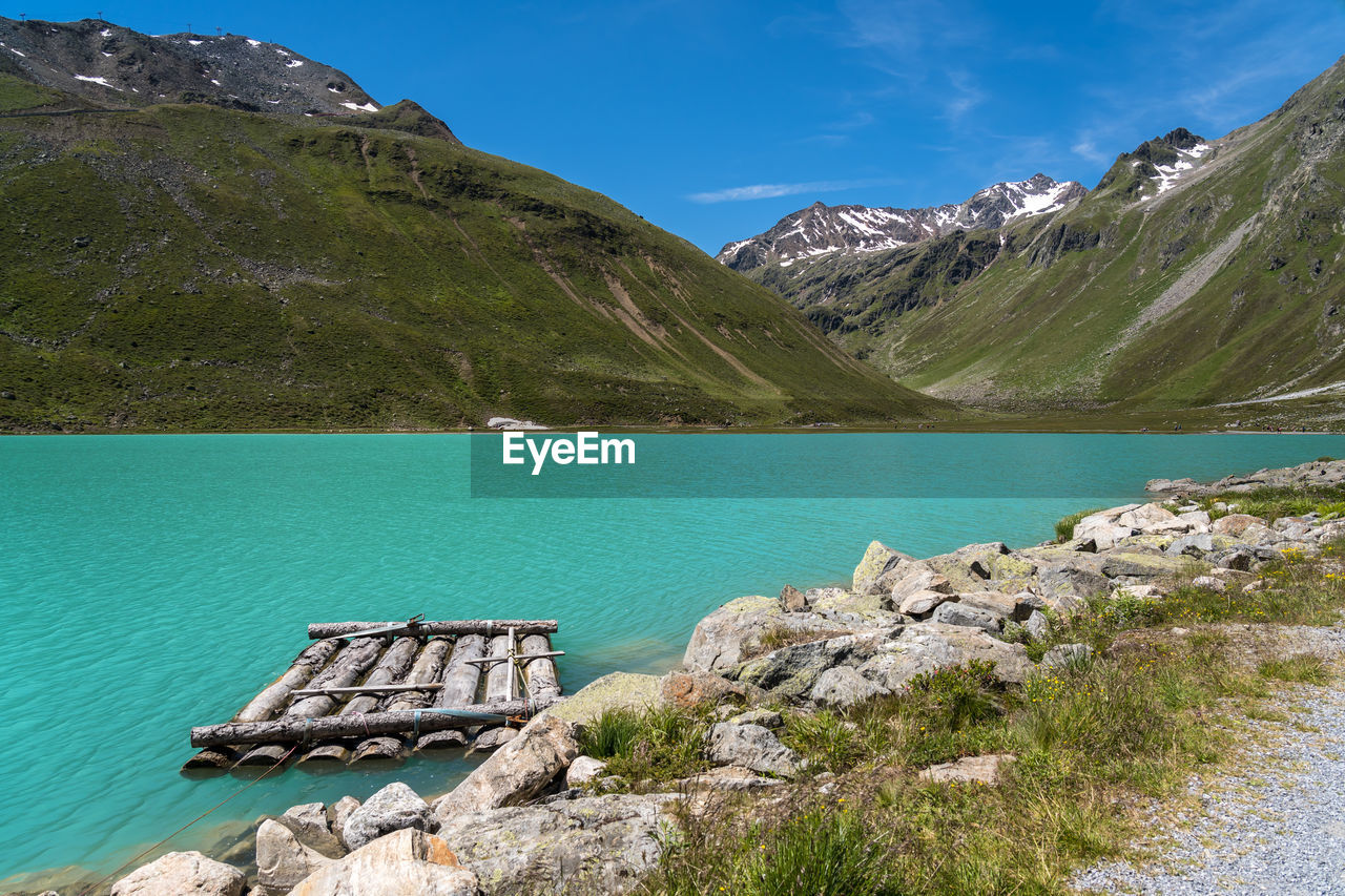 SCENIC VIEW OF LAKE AGAINST MOUNTAIN