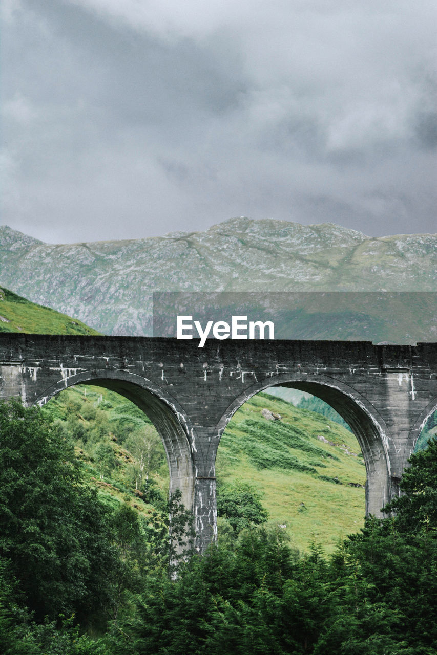 Arch bridge against sky. viaduct
