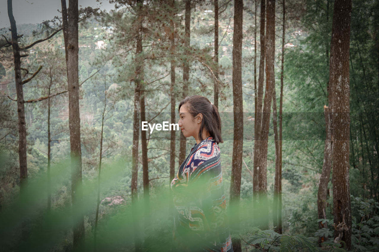 Side view of woman in forest