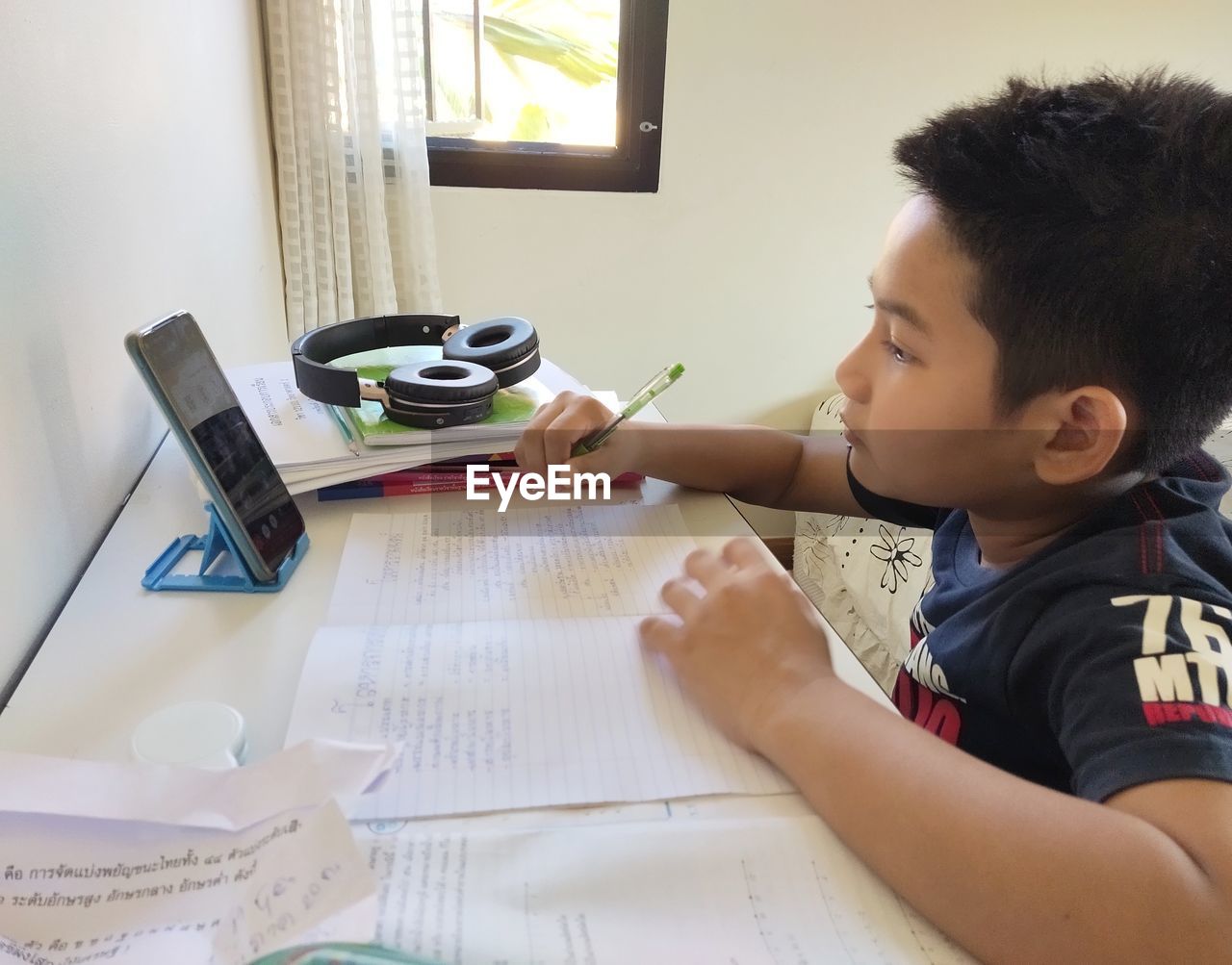 Boy holding book at home