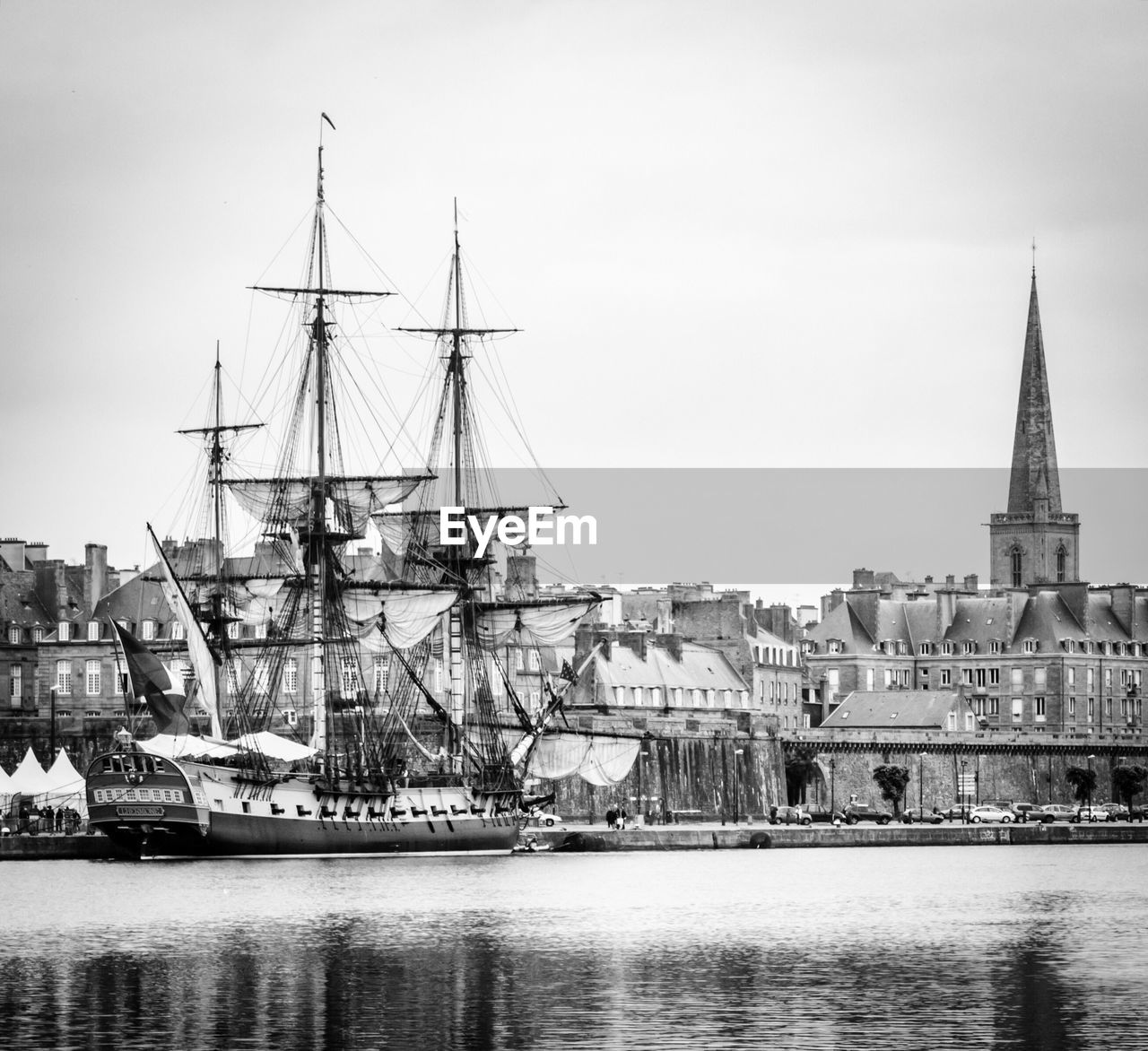 Boats in river with buildings in background