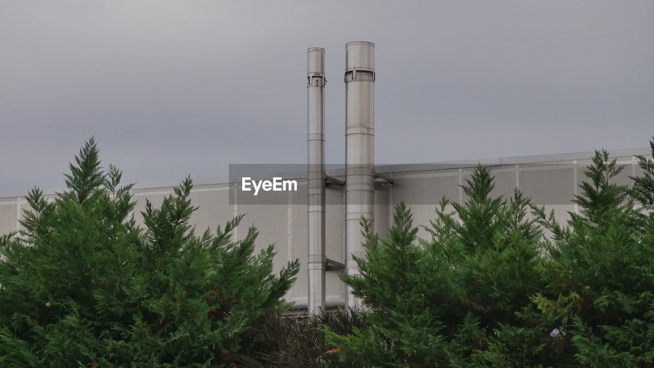 plant, nature, architecture, built structure, tree, sky, building exterior, no people, factory, tower, wind, outdoor structure, industry, growth, outdoors, power generation, day, green, environment