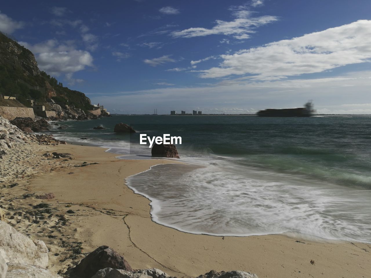 View of beach against cloudy sky