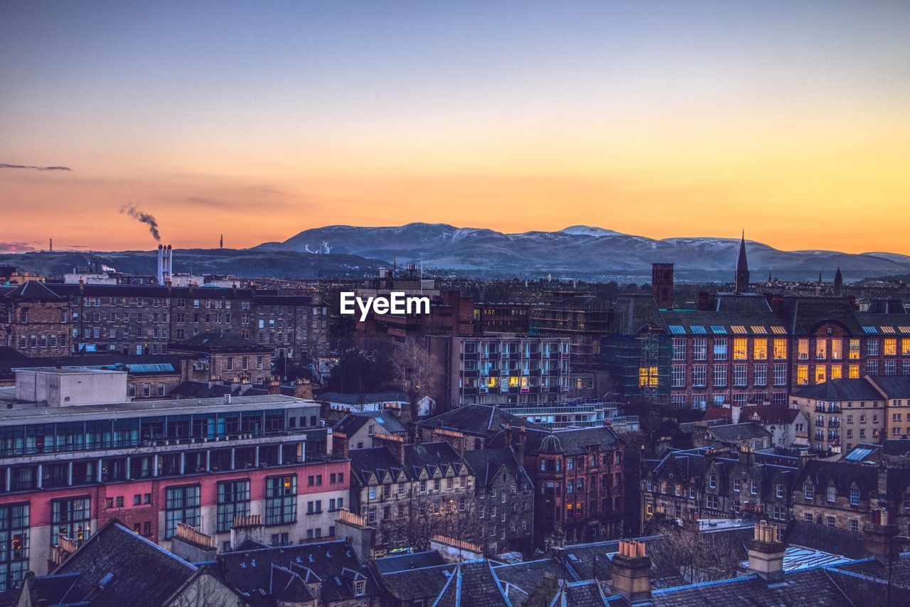 High angle shot of edinburgh townscape against sky at sunset