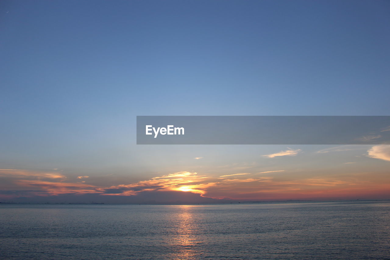 SCENIC VIEW OF SEA AGAINST ORANGE SKY