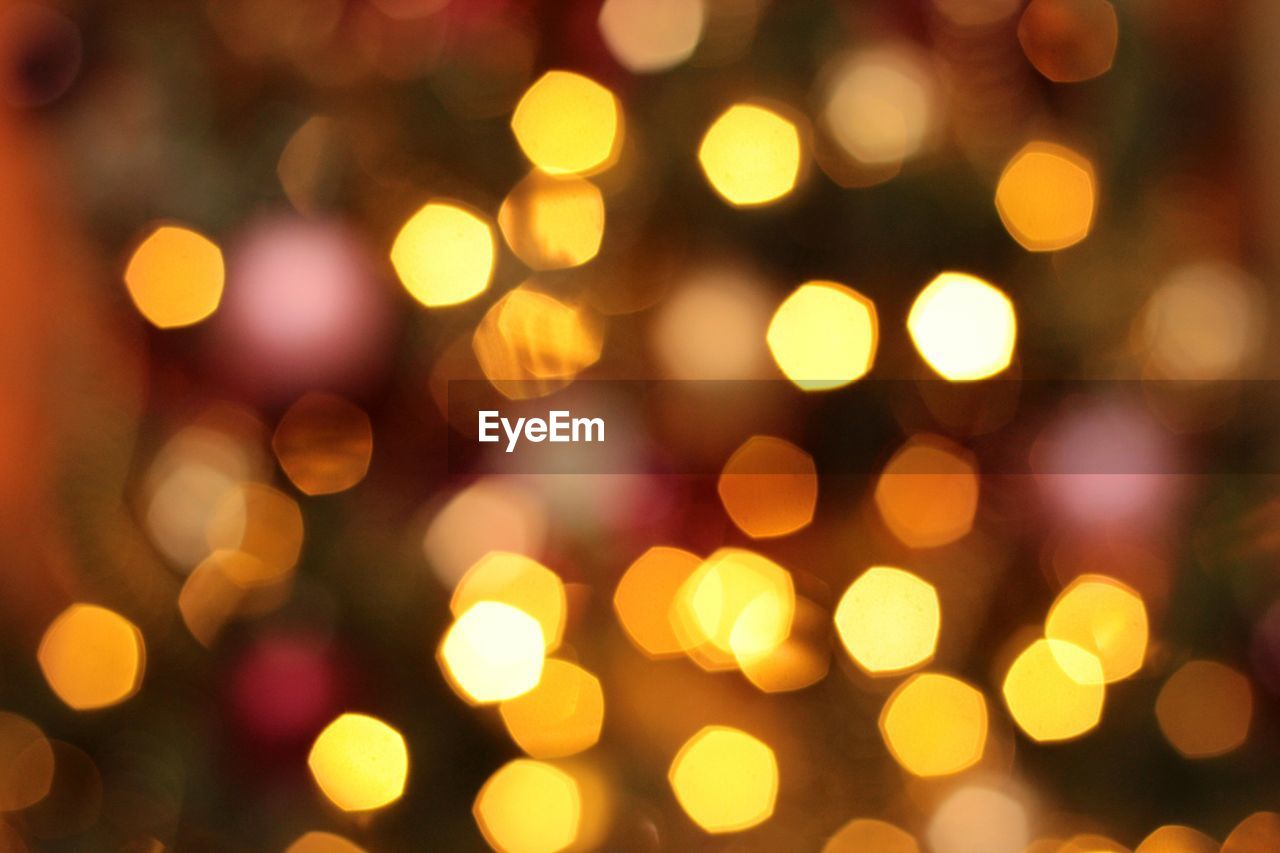 DEFOCUSED IMAGE OF ILLUMINATED CHRISTMAS LIGHTS