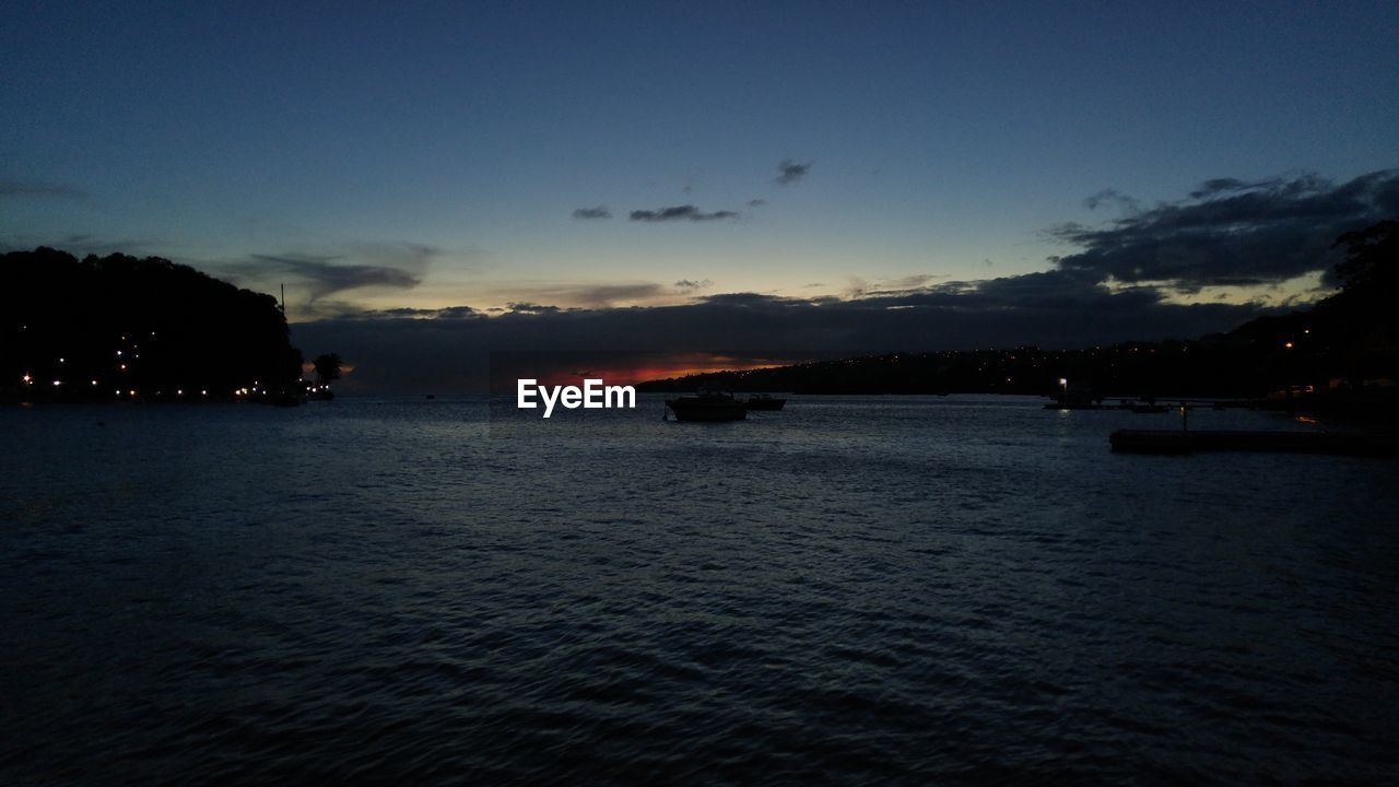 Scenic view of sea against sky at dusk