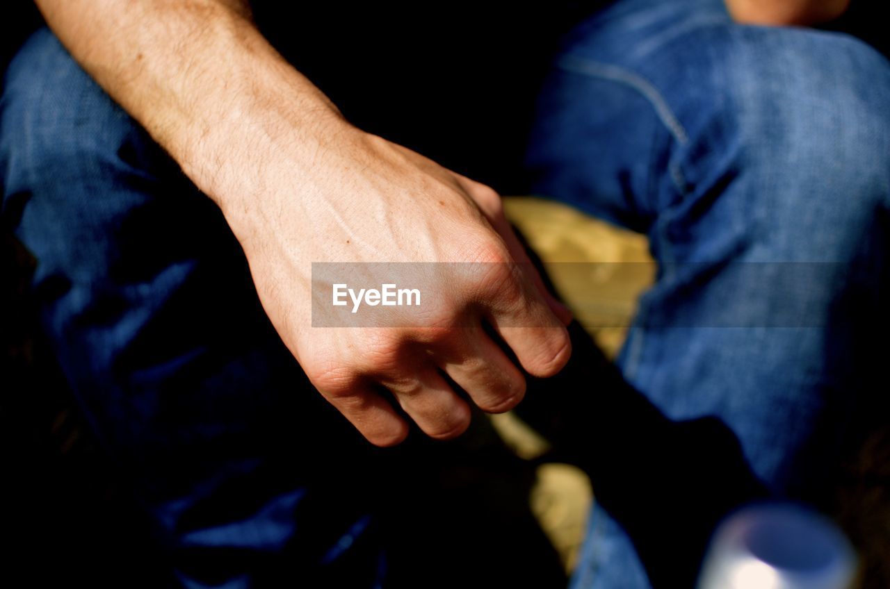 Cropped image of person sitting on chair