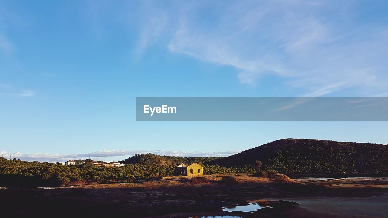 Scenic view of mountains against blue sky