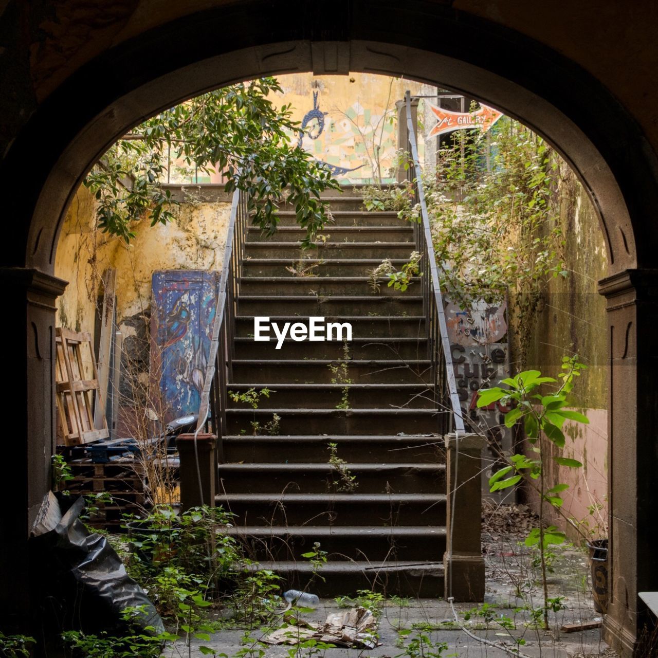 Abandoned steps seen through arch