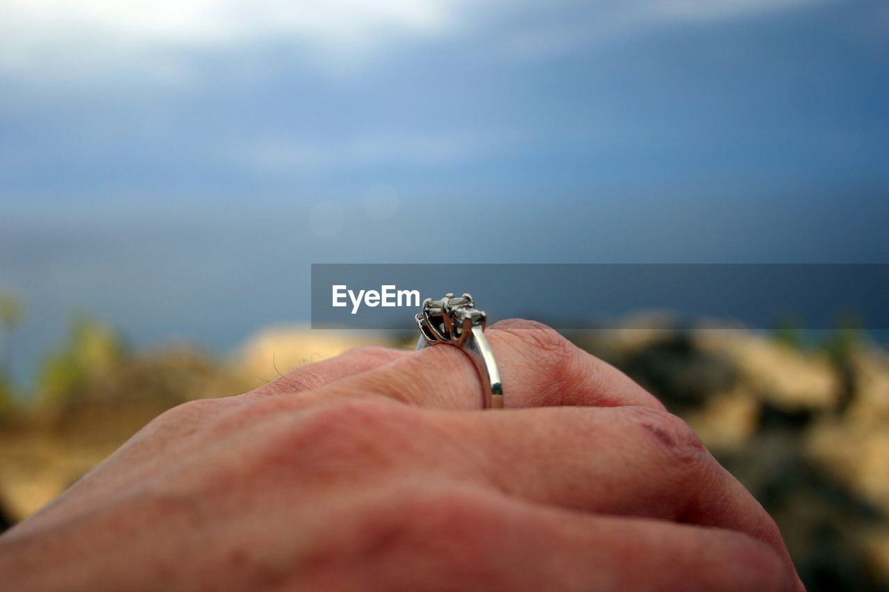 Cropped image of woman wearing engagement ring