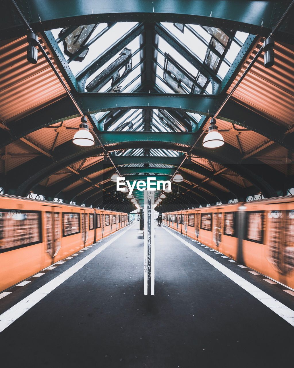 Blurred motion of trains at railroad station platform